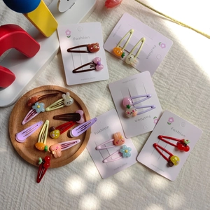 Close-up of cute cartoon rabbit and flower charms on colorful children's hair clips