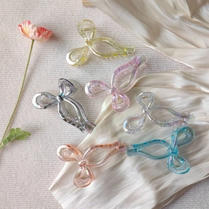 Set of 6 colorful iridescent bow hair claws in transparent acrylic for elegant hairstyling