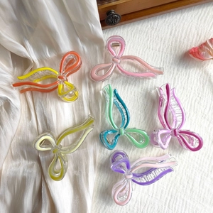Macro display of assorted resin butterfly hair claws in various elegant pastel colors
