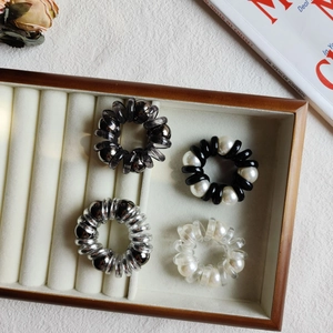 Set of four stylish pearl telephone wire hair ties with metallic finish in a jewelry box