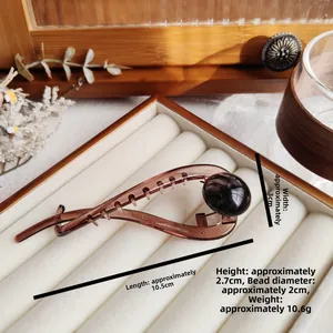 Detailed size specifications of the amber brown banana hair clip with large beads