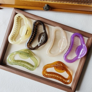 Top view of six large jelly-colored cloud hair claws in diverse pastel shades and matte finish