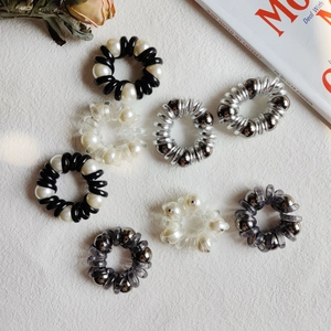 Eight-piece pearl spiral telephone wire hair ties in black, white, and silver styles