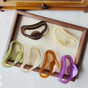 Detail of Korean jelly colored shark hair clips in six assorted matte and pastel shades