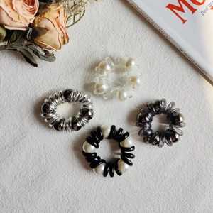 Set of four stylish spiral hair ties with faux pearls and metallic beads for women