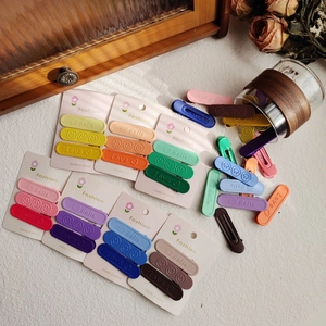 Set di 3 fermagli per capelli opachi colorati con motivi a rilievo su scheda
