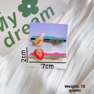 Detailed view of glitter fruit hair clips showing 7cm length and 2cm width dimensions