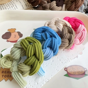 Set of colorful braided elastic hair ties in mint green, blue, and coffee tones