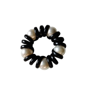 Fashionable spiral hair tie with black telephone wire cord and five white elegant pearls