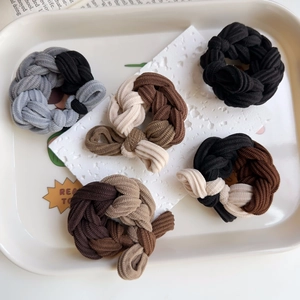 Set of 5 thick braided elastic hair ties in neutral tones on a ceramic tray