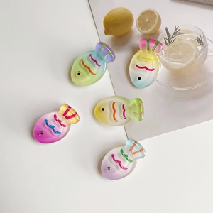 Five colorful gradient fish hair clips with jelly texture on a fresh summer background