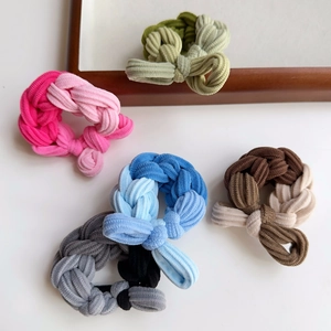 Detailed view of colorful woven elastic hair ties with textured cord and knot design