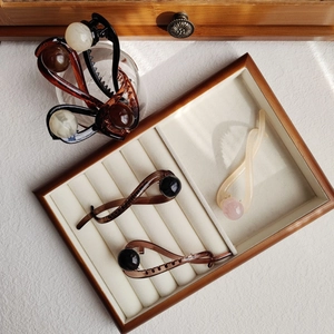Detail view of twisted hair claws with smooth resin finish and pearl accents in earthy tones