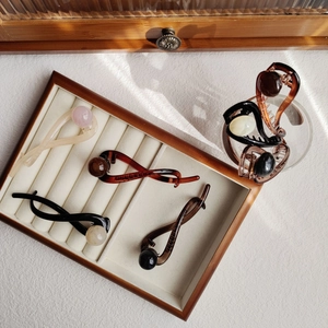 Detail of twisted resin hair clips with faux pearls and rhinestones in autumn colors