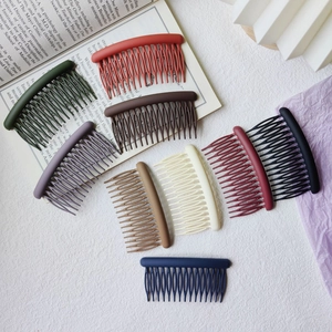 Close-up of matte finish hair side combs in multiple colors for hair styling