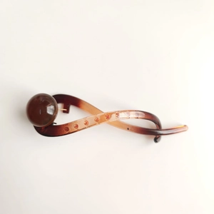 Minimalist amber brown resin hair claw clip with vintage twist design and bead detail