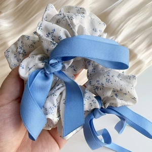 Detailed view of sea salt blue floral scrunchie with elegant long flowing ribbons