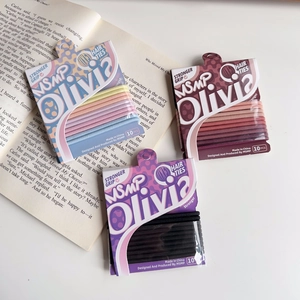 Detail of colorful high elastic hair ties set with paper card packaging on a book