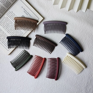 Detail of nine multi-colored matte finish hair combs with curved teeth structure