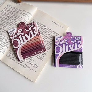 Detail of 10-piece high-elastic hair tie sets in candy colors and black on a book