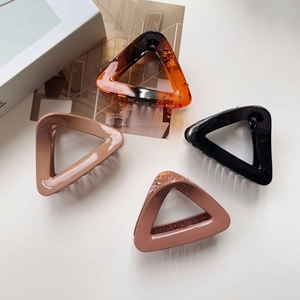 Set of four large triangular matte hair claws in amber, black, beige, and pink colors