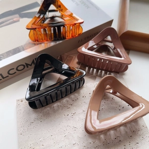 Detail view of triangular hollow claw clips in tortoiseshell and solid colors set