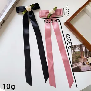 Pink and black ribbon bow hair clips with white rose flowers and long satin streamers