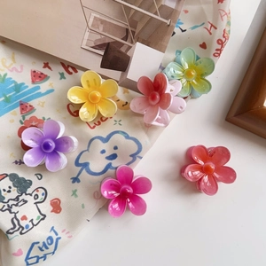 Detail of colorful mini flower hair claws in purple pink and yellow candy colors