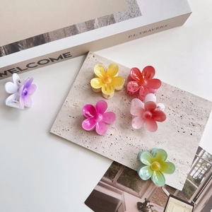 Detailed collection of colorful floral hair claws in pearlescent pastel finishes