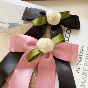 Elegant satin ribbon bow hair clip with rose flower detail in pink and black colors