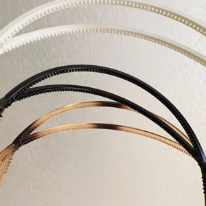 Detail view of non-slip teeth on minimalist thin cross hairbands in three colors