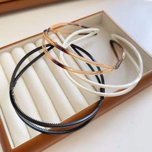 Set of three non-slip headbands in black, white, and tortoiseshell with teeth detail