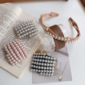Vue à plat d'un serre-tête et barrettes à perles vintage sur un bureau esthétique