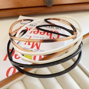 Detail of multi-color non-slip headbands with teeth on decorative book and tray
