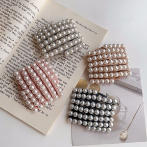 Serre-tête pliable en perles en quatre couleurs sur fond de livre ancien ouvert