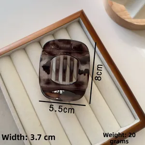 Detail view of large tortoise shell hair claw clip with dimensions 8cm x 5.5cm