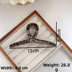 Detailed view of leopard print hair claw clip showing 13cm length on white display tray