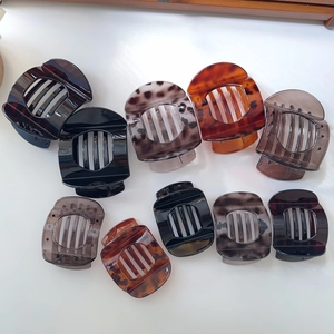 Flat lay of diverse large tortoise shell and acrylic claw clips set in various colors