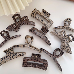 Detailed collection of leopard print hair claws in various vintage bow and square styles