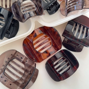Macro detail of tortoiseshell hair claws in various colors and sizes with metal springs