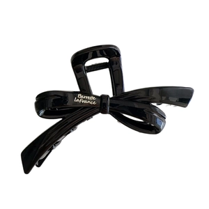 Elegant black resin bow hair claw clip with white Barrette LaFrance script for women