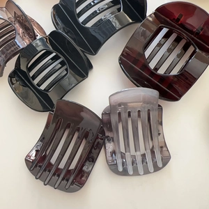 Flat lay view of large vintage tortoiseshell hair claws in assorted dark colors