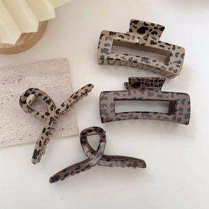 Set of four leopard print hair claws in brown and beige tones for elegant hair styling