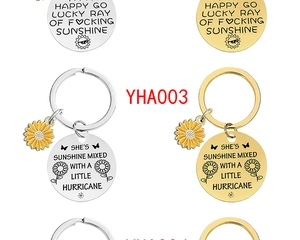 Detailed close-up of engraved metal sunflower keychains with motivational phrases
