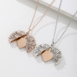 Detailed view of rose gold and silver sunflower lockets with movable petals and heart centers