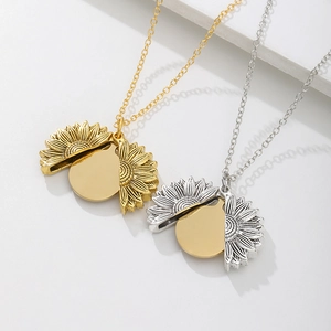 Macro shot of opening sunflower locket pendant necklace in gold and silver finish