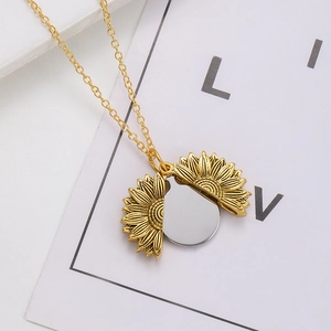 Detail of sunflower pendant necklace with a foldable mechanism and engravable silver disc