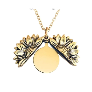 Detail of vintage sunflower locket necklace with opening design and inner metal plate