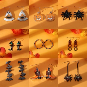 Macro shot of nine pairs of Halloween earrings with ghosts, pumpkins, and spiders