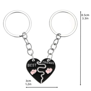 Two-piece black enamel heart puzzle keychain set with BEST FRIENDS engraving for couples